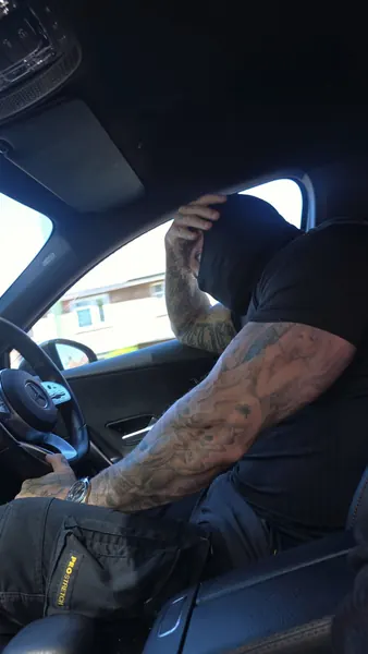 Zade, black balaclava. In the driver's seat.