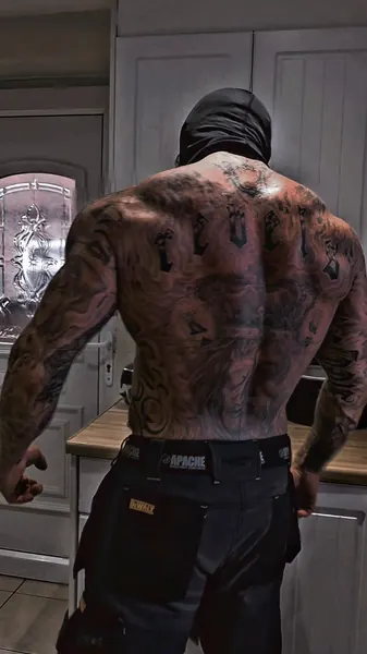 Zade, black balaclava. Back view showing back tattoos.