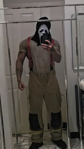 Zade, ghostface. Mirror selfie in tee, braces and firefighter trousers.
