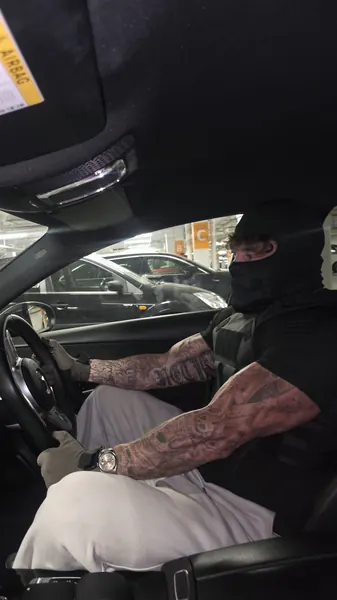 Zade, black balaclava. Driving.