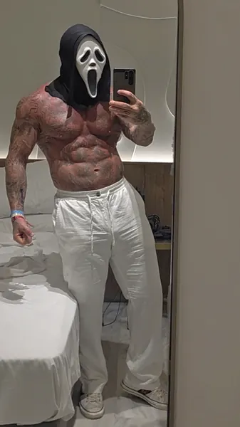 Zade, ghostface. Shirtless mirror selfie, white trousers.
