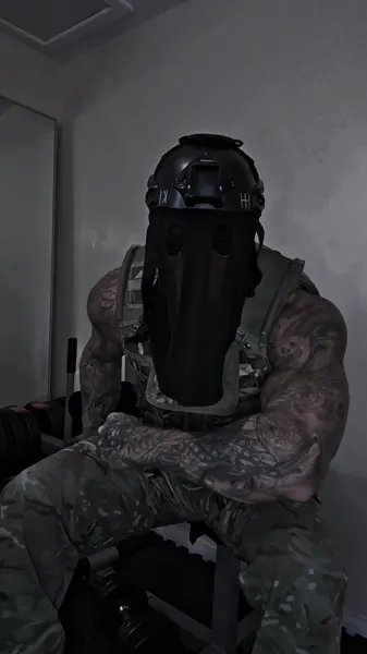 Zade, tactical helmet & veil. Seated in helmet, face veil and plate carrier.