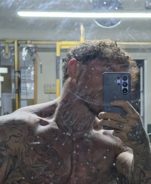 Zade, face hidden. Close-crop gym mirror selfie, phone over face.